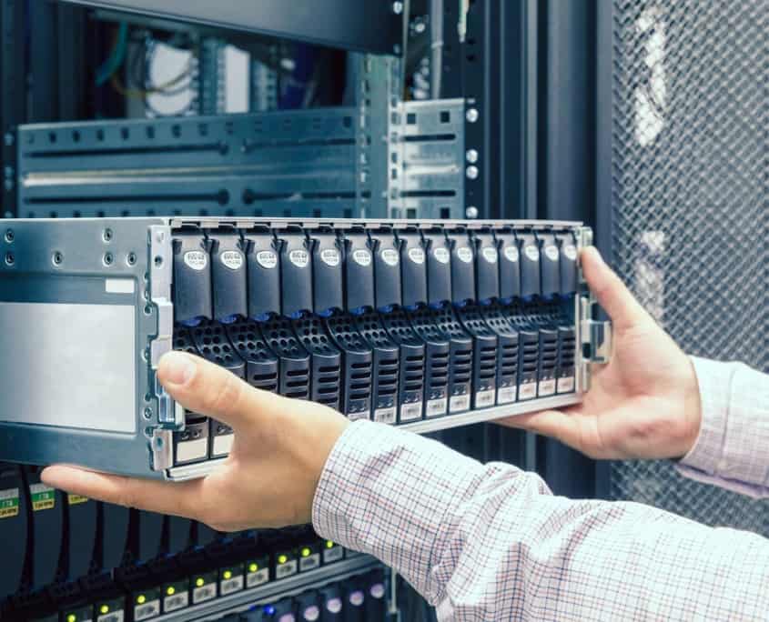 Home it worker pulling out large server rack 845x684